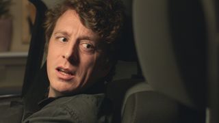 Jack Wilkinson as dad-to-be Aaron Bayliss in the driver seat of his car after it crashes into a restaurant.