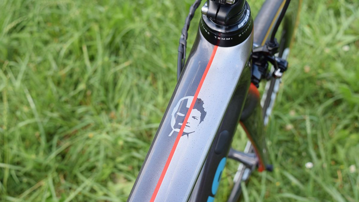 Fuglsang's face is split with an Iron Man design at the head of the top tube