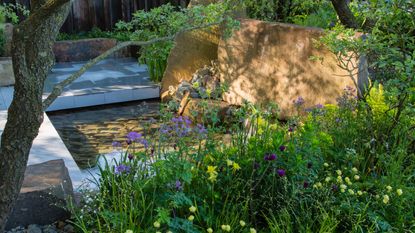 a rock garden with a pond