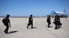 Members of the Secret Service counter-assault team walk toward Air Force One on Aug. 25, 2024.