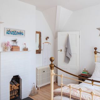 white bedroom with wrought iron bed frame and vintage accessories