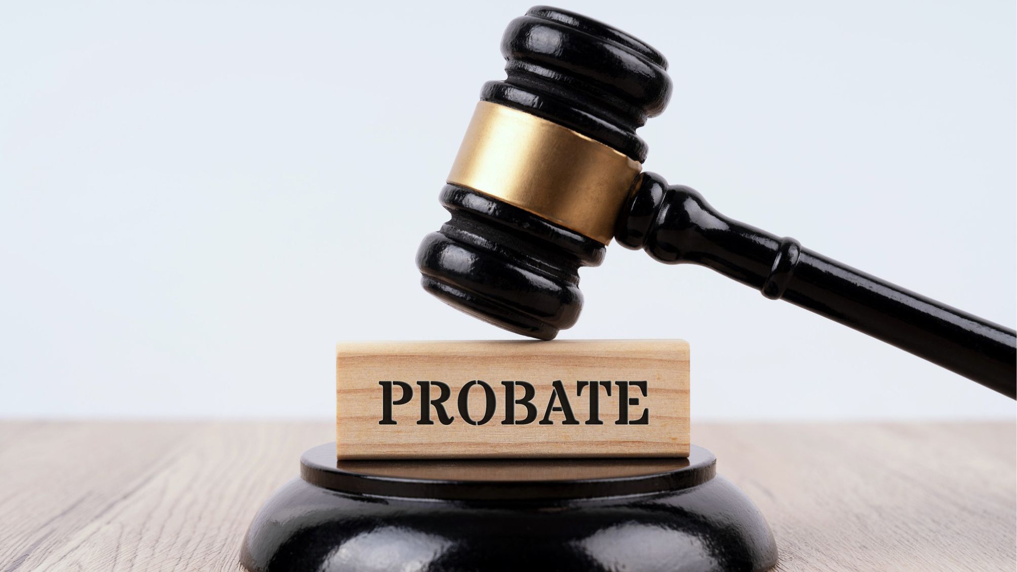 A gavel on top of a block with the word probate on it.