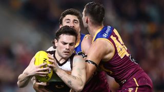 Hawthorn's Nick Watson being tackled by Brisbane's Noah Answerth in an AFL game