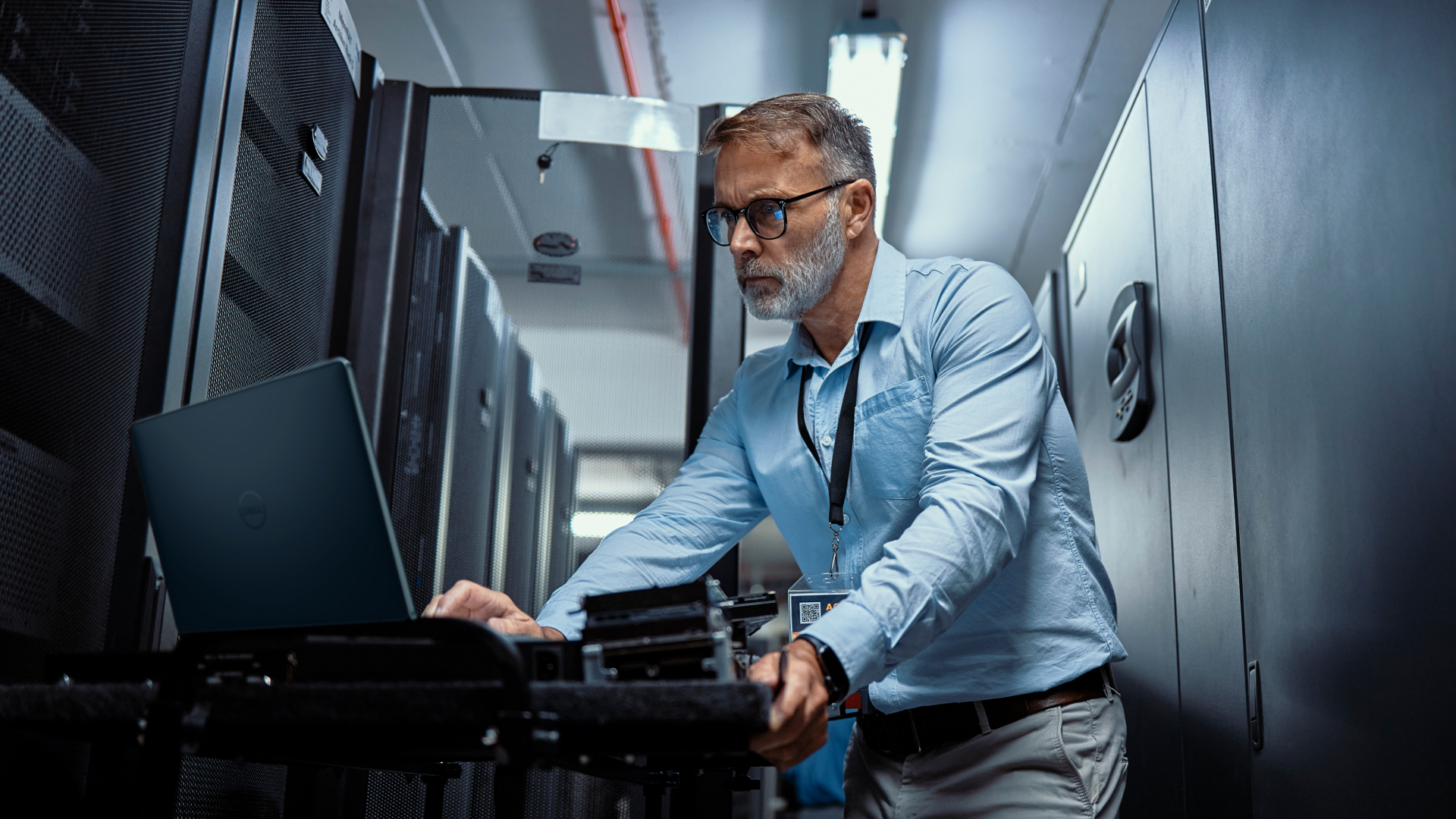 Employee using a Dell laptop next to servers