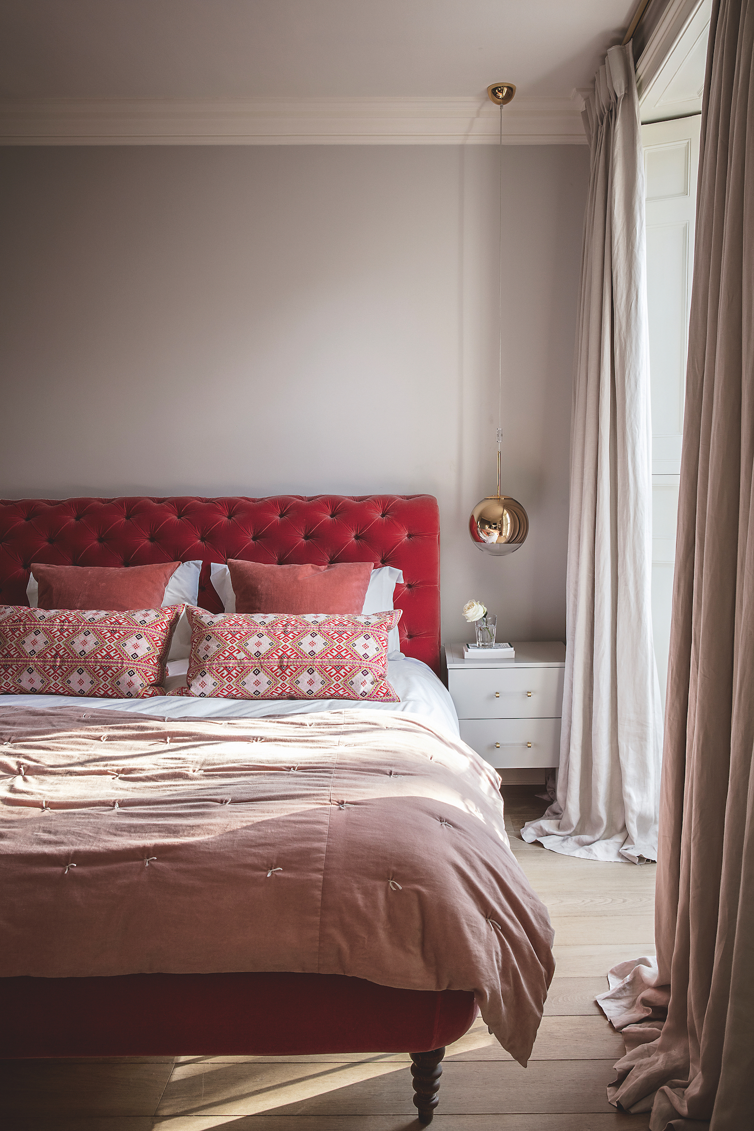Pink and red modern bedroom with hanging bedside lamp