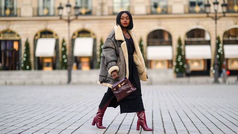 paris, france december 06 fashion blogger linaose wears a bombardier aviator browngray jacket with sheep wool inner lining from acne studio, a black slit dress from sancia, a burgundy leather bag kelly hermes 28, purple leather crocodile pattern high heeled pointy boots from bianca di, on december 06, 2020 in paris, france photo by edward berthelotgetty images
