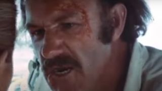 Gene Hackman with a mean face and a mustache in Night Moves