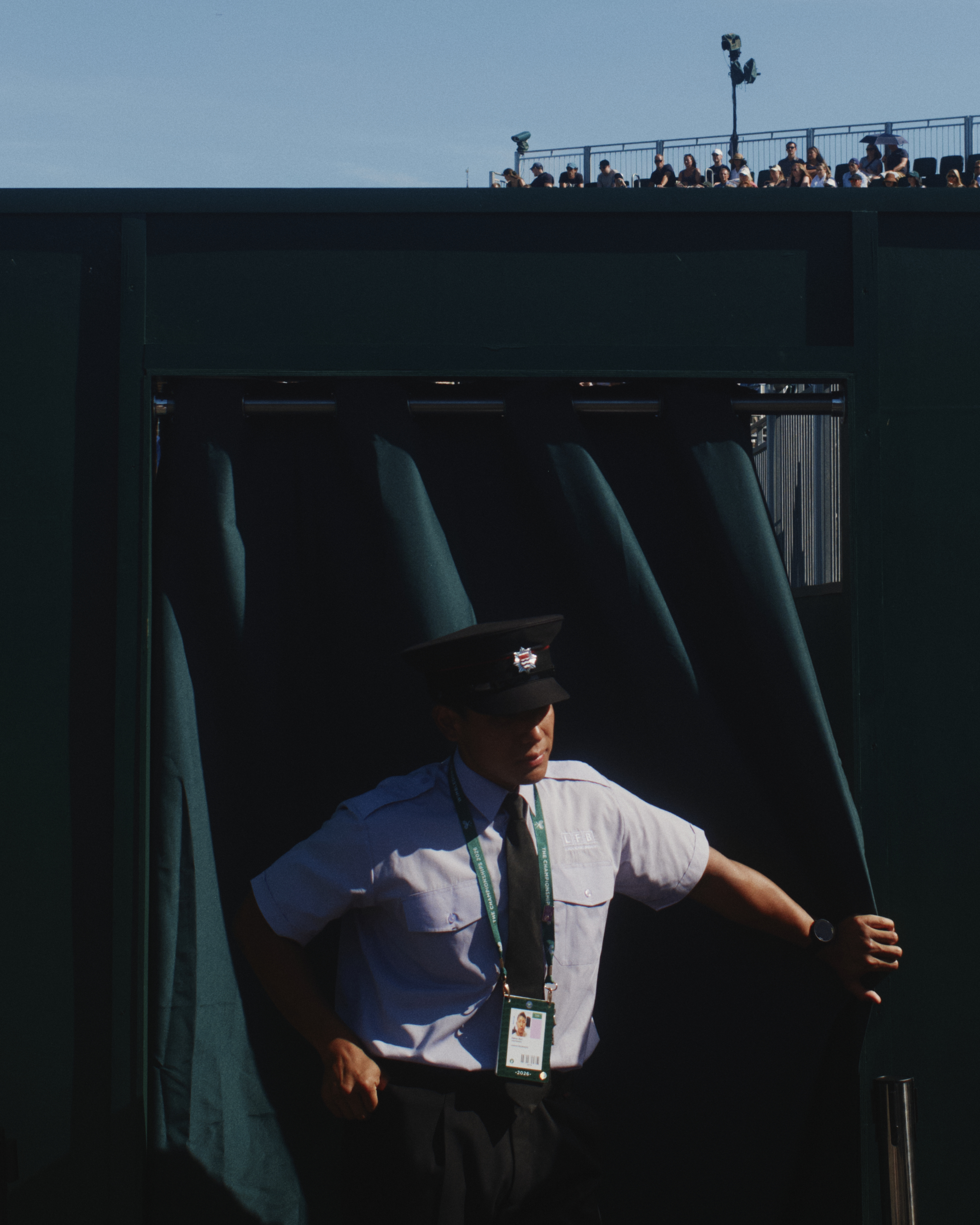 Wimbledon official in cap, with lanyard