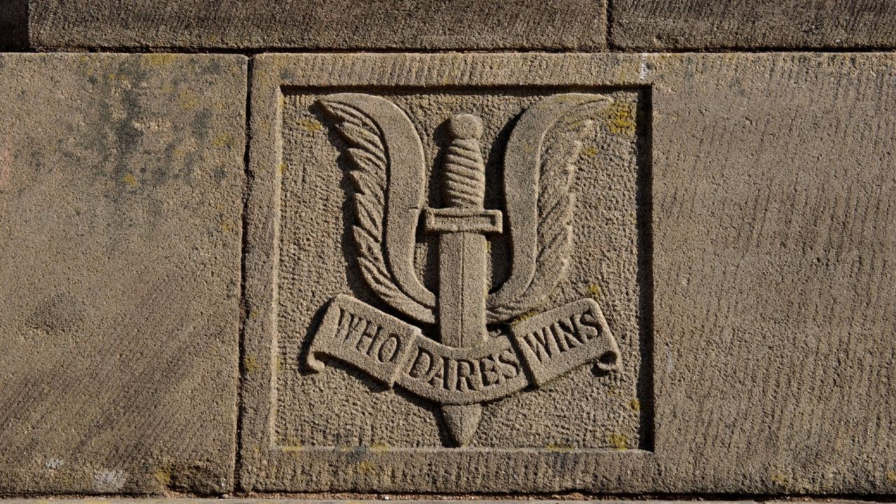 SAS crest reading ‘Who Dares Wins’, as seen on a war memorial