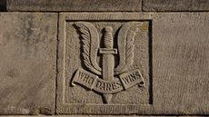 SAS crest reading ‘Who Dares Wins’, as seen on a war memorial