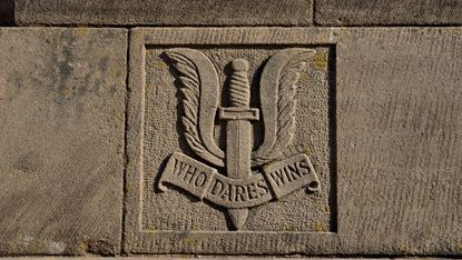 SAS crest reading ‘Who Dares Wins’, as seen on a war memorial