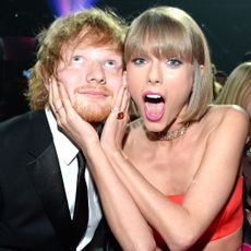 Ed Sheeran and Taylor Swift posing together as she holds his face at the 58th GRAMMY Awards at Staples Center on February 15, 2016