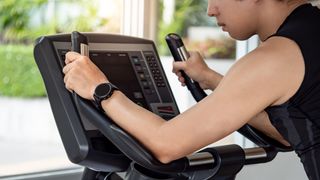 Close up on person looking at screen of an exercise bike