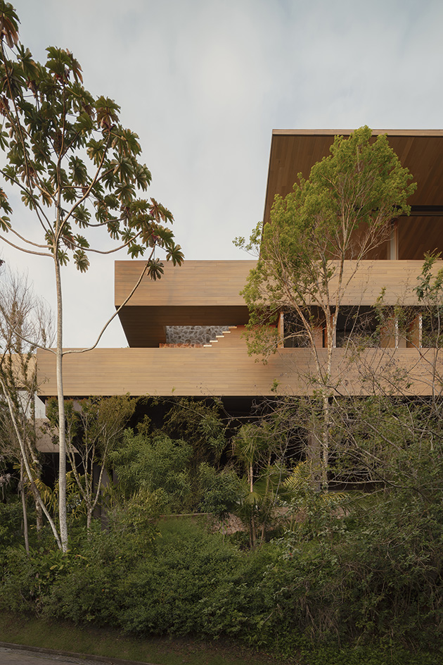 Bravissima House by Arthur Casas, a brazilian house nestled among the forest canopy and rising above the foliage to long views from large windows and ample terraces