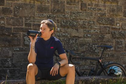 rider sitting down having a drink