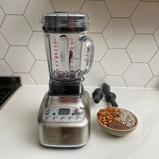 Sage Super Q blender next to bowl of nuts and seeds