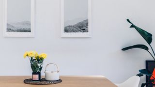 How to make your home look expensive: image of table and two pieces of art on wall