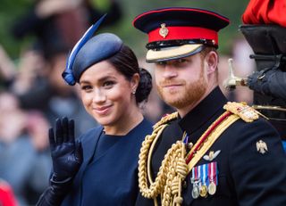 Prince Harry, Duke of Sussex and Meghan, Duchess of Sussex ride by carriage down the Mall during Trooping The Colour