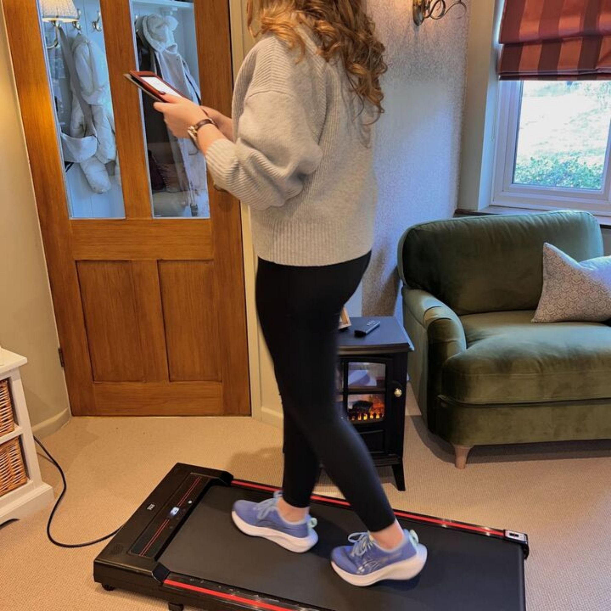 Layla Al-Ani using her kindle while on her walking pad.