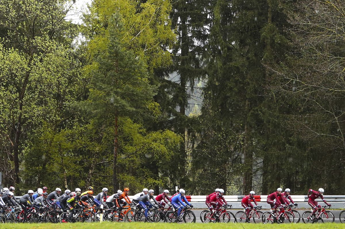 A rugged up peloton rolls along