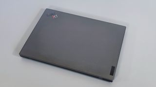 A photograph of the Lenovo ThinkPad X1 Carbon Gen 10 closed on a table