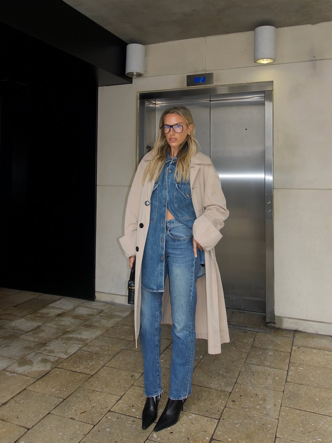 An image of a woman wearing sun faded jeans, a major denim trend 2026.
