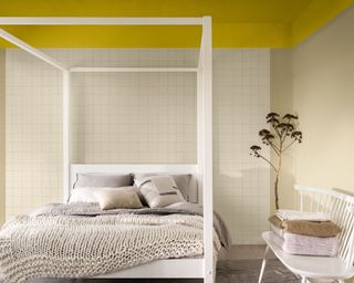 calming bedroom with neutral walls, bright yellow ceiling and white four-poster bed