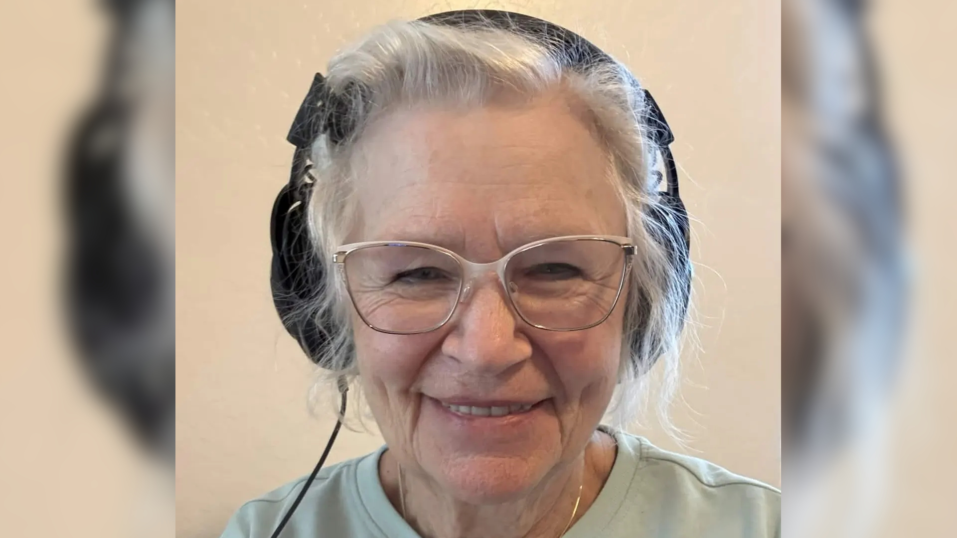 An image of GrammaCrackers, smiling and wearing headphones.