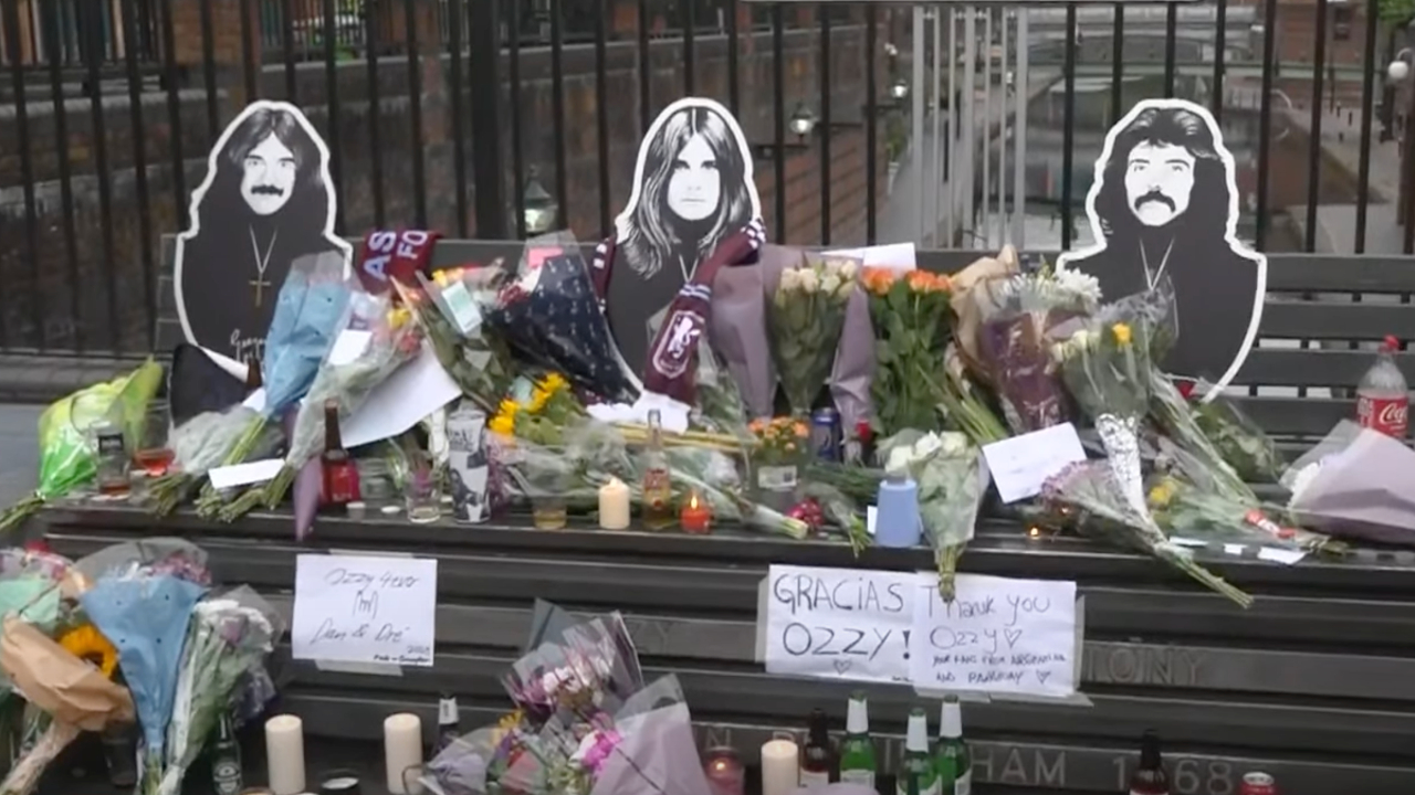 An image of the Black Sabbath bench adorned with flowers