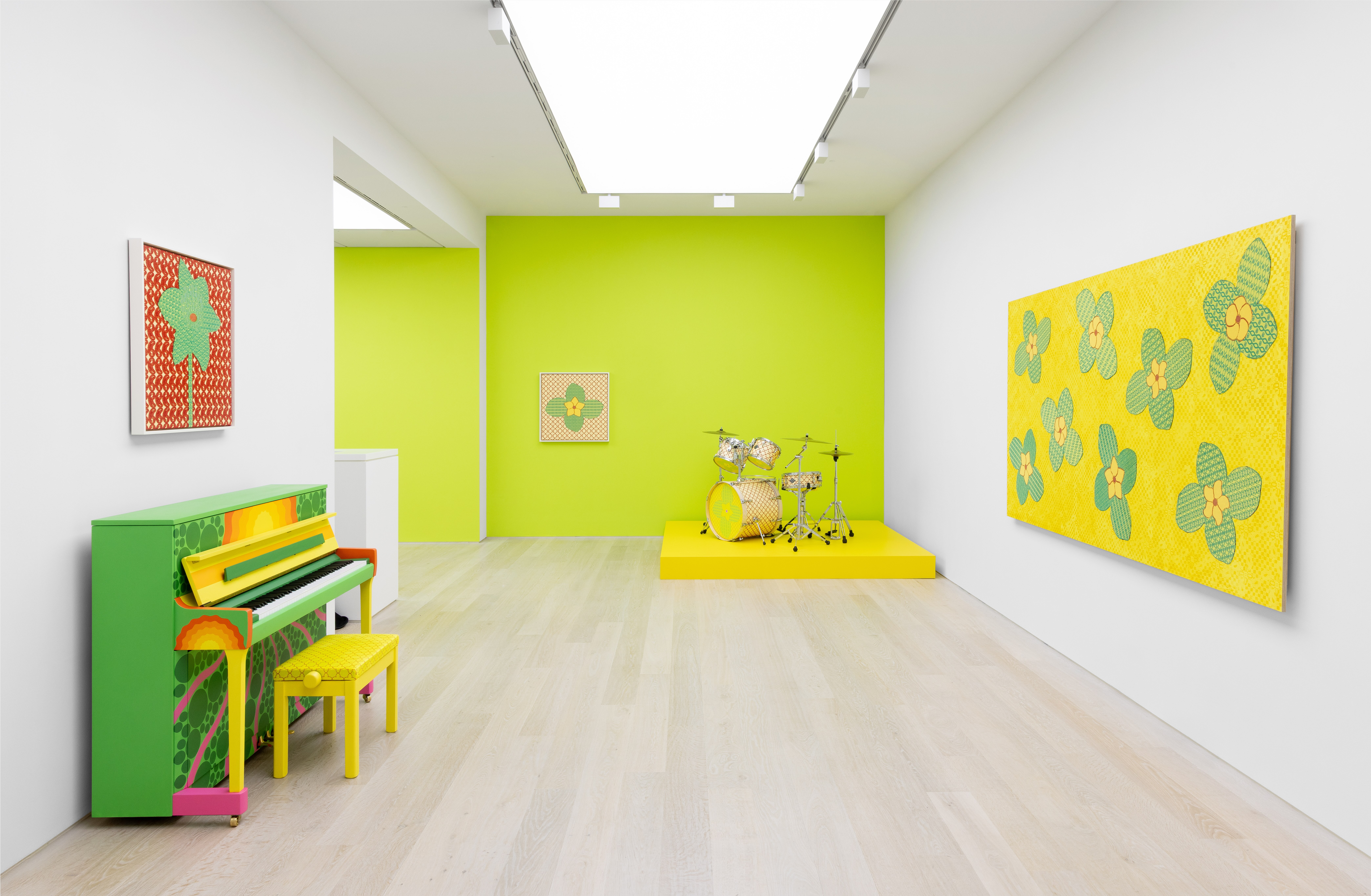 Gallery featuring green and yellow piano and motif artwork on the wall