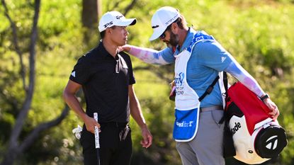 Collin Morikawa is consoled by his caddie at Kapalua