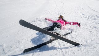 A skier lying on her back