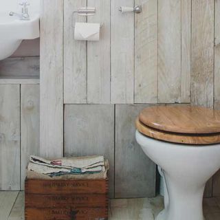toilet with wooden wall and flooring