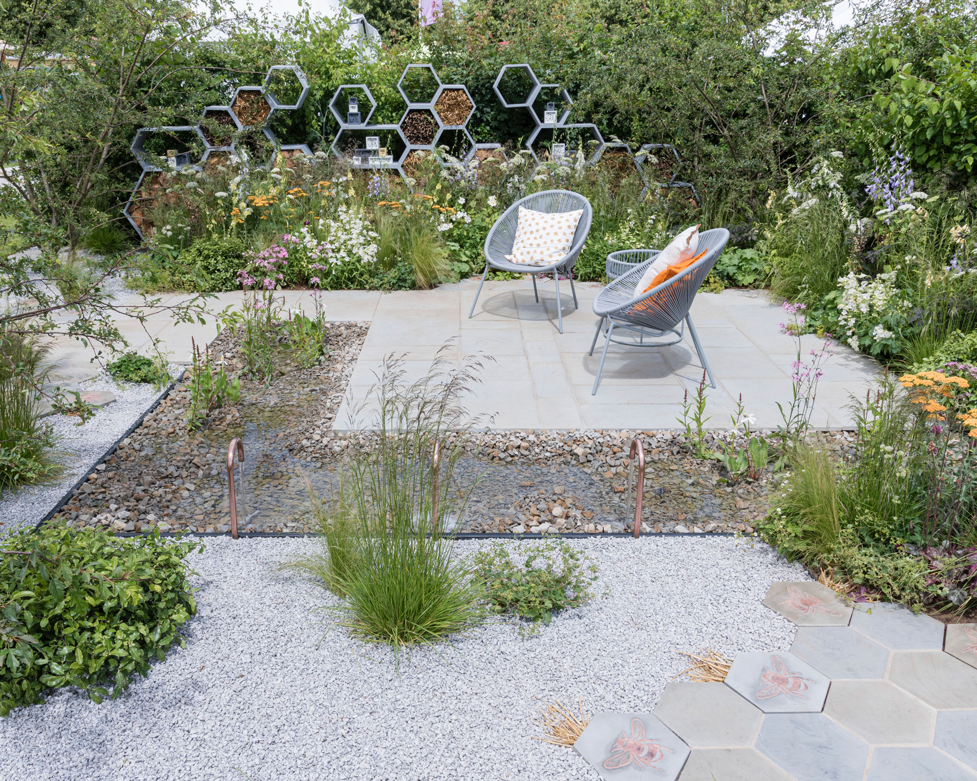 modern pollinator pond with gravel and planting in urban garden design