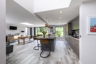 modern kitchen diner extension with wooden flooring and picture window