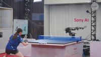 A still from a video showing Sony's Ace robot arm playing table tennis against a professional player