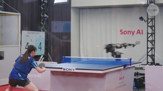 A still from a video showing Sony's Ace robot arm playing table tennis against a professional player