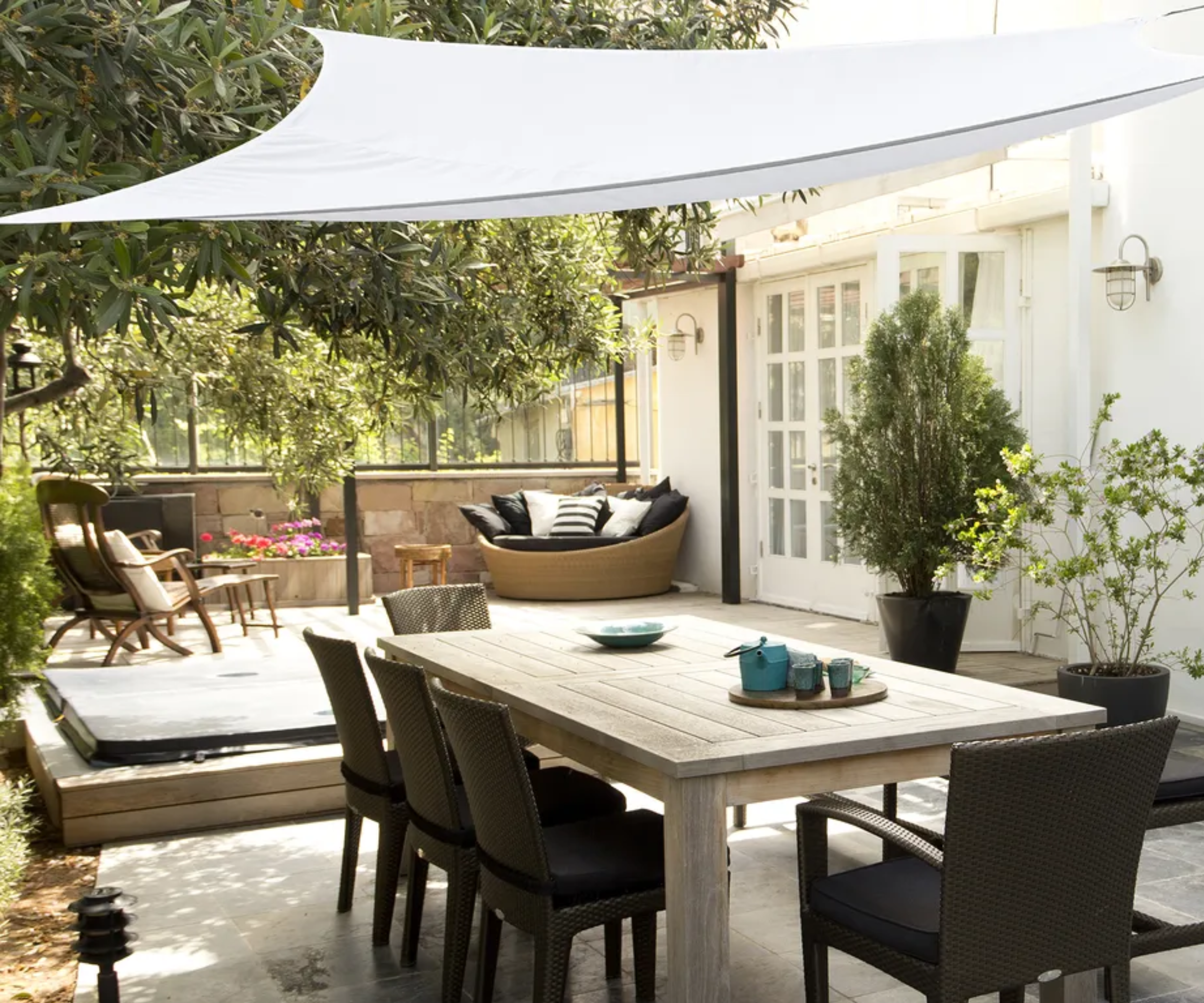 White shade sail over dining table outside