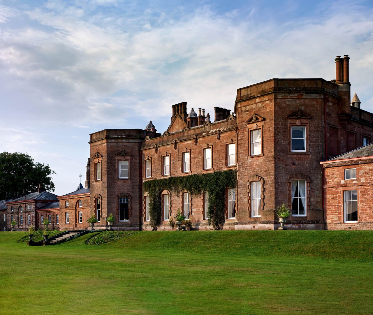 Fig 1: The Georgian façade with its central block, to which were added pavilions — Netherby Hall. ©Paul Highnam for Country Life