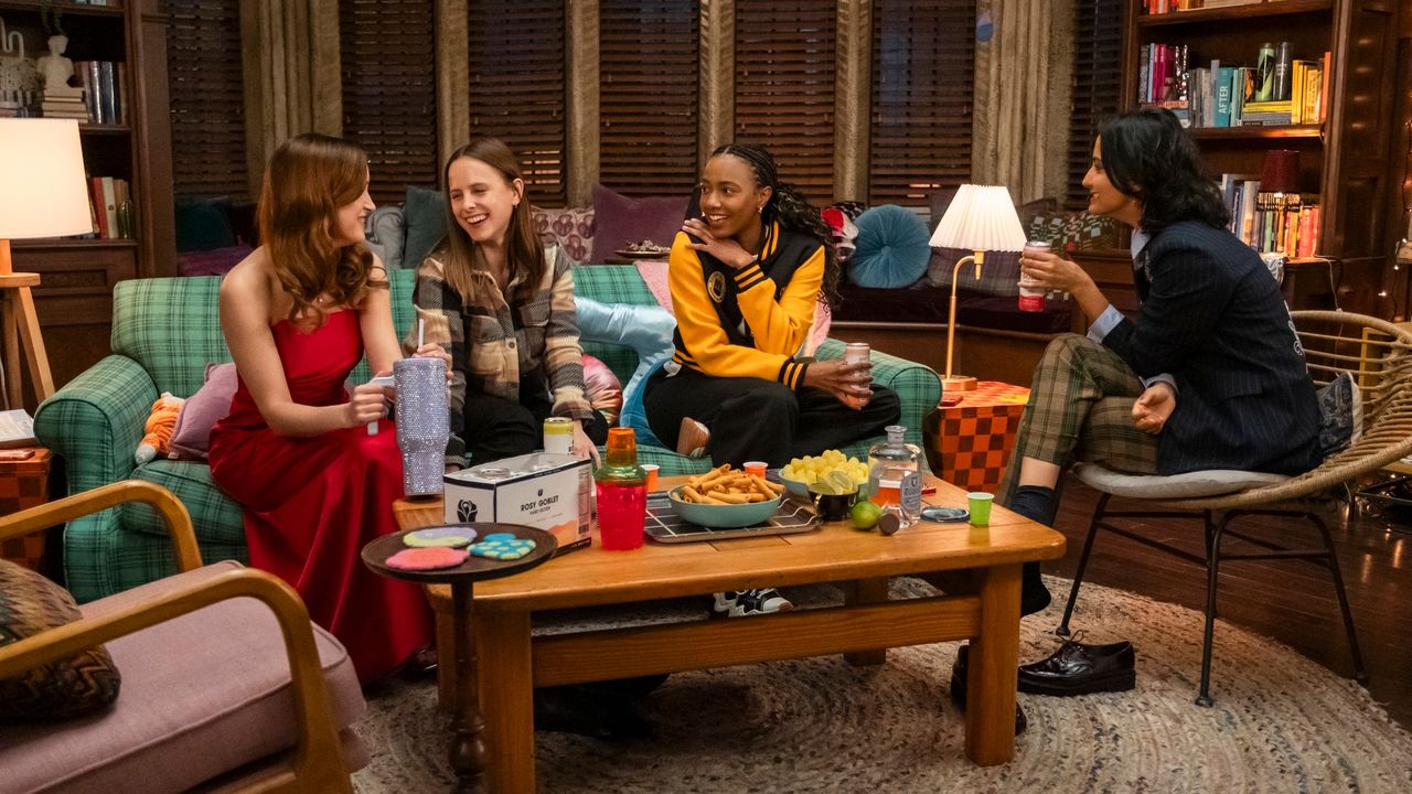 Four college students (Gracie Lawerence, Pauline Chalamet, Alyah Chanelle Scott, Amrit Kaur) hold drinks while sitting around a coffee table in a dorm room, in &#039;The Sex Lives of College Girls.&#039;