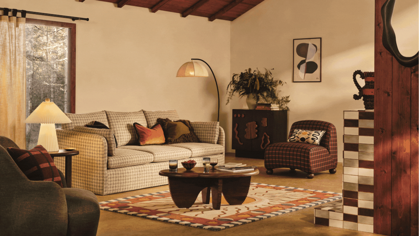 Rotating GIF of stylish living rooms arranged with cozy furniture. The images highlight things like a checkered sofa, cozy lighting, curtains hung around the room, sculptural furniture, and Christmas decor.