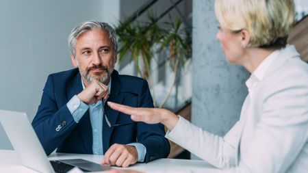 A man listens closely to what his financial adviser is saying.