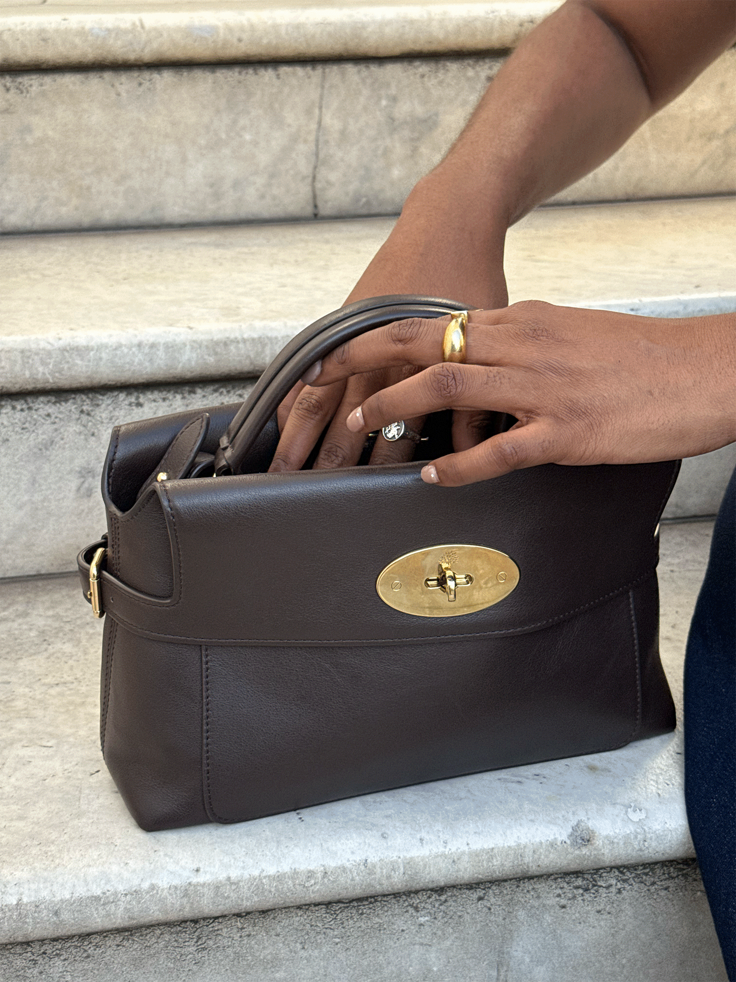 A fashion editor styles the Small Stevie Top Handle in Ebony Supple Smooth Leather