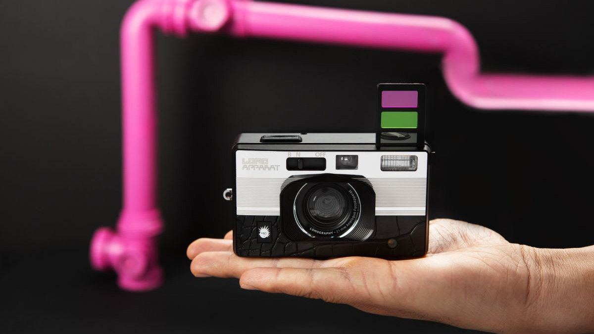 The Lomography LomoAppart Alexanderplatz compact film camera in a person's hand