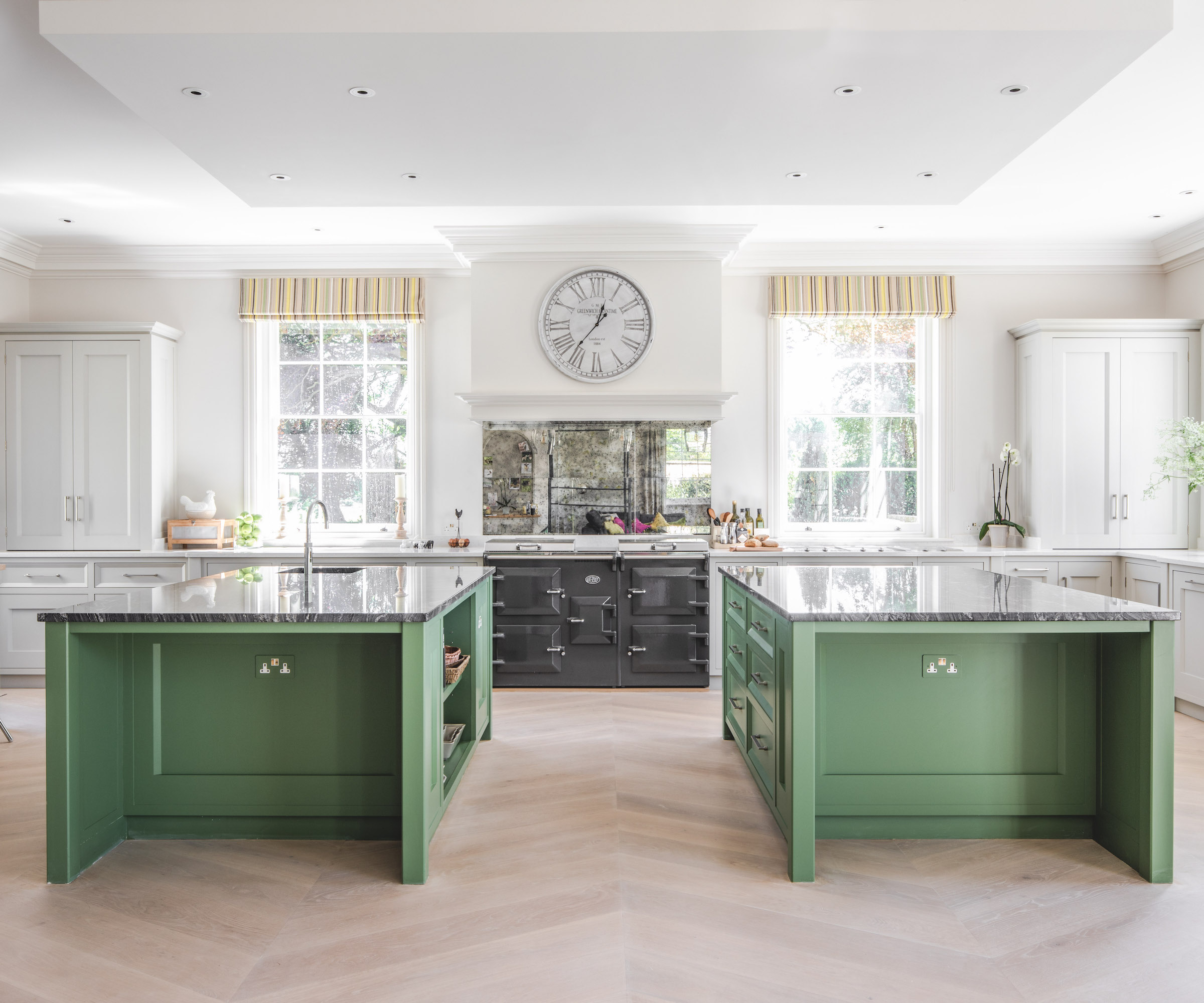 off-white kitchen with two green islands