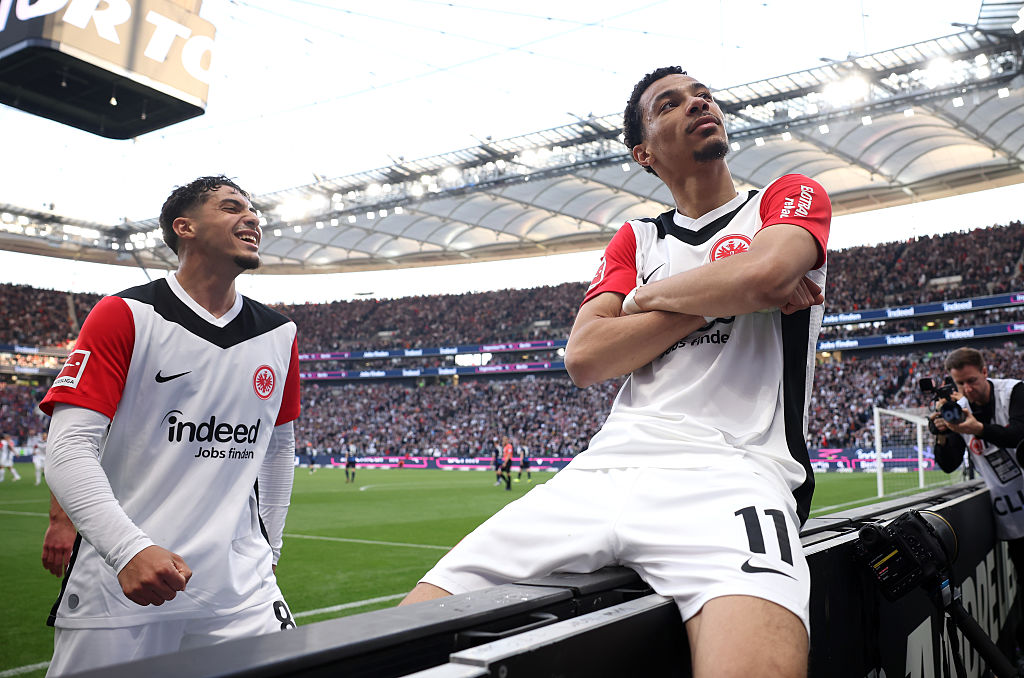 Liverpool target Hugo Ekitike of Eintracht Frankfurt celebrates scoring his team's third goal with teammate Fares Chaibi during the Bundesliga match between Eintracht Frankfurt and 1. FC Heidenheim 1846 at Deutsche Bank Park on April 13, 2025 in Frankfurt am Main, Germany.