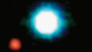 a large bright white and blue mostly round shape in the center and to the lower left is a smaller red blob.