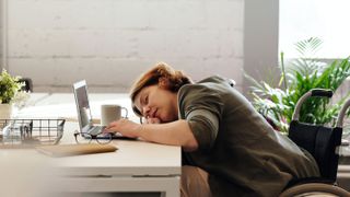 A woman asleep at her desk