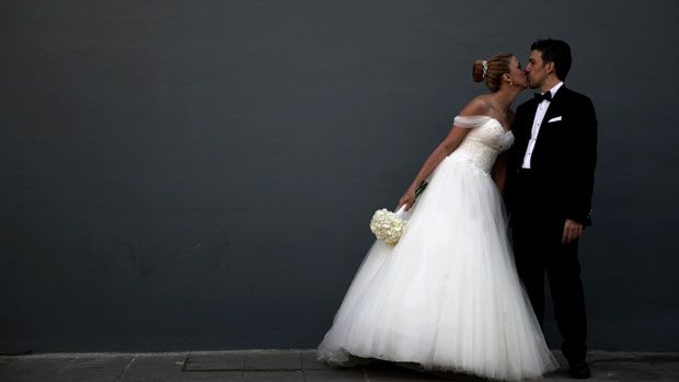 Newlyweds pose for a picture after their wedding ceremony