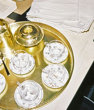 gold tray with cups and saucers, jewellery homeware by Foundrae at Browns